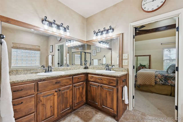 4733 S 167th E Pl, Tulsa, OK 74134 - ensuite bathroom with double vanity, tile patterned floors, and healthy amount of natural light
