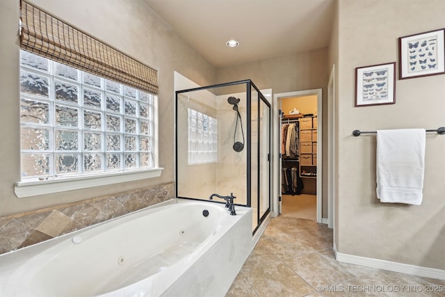 4733 S 167th E Pl, Tulsa, OK 74134 - bathroom with a stall shower, a tub with jets, a spacious closet, and tile patterned floors
