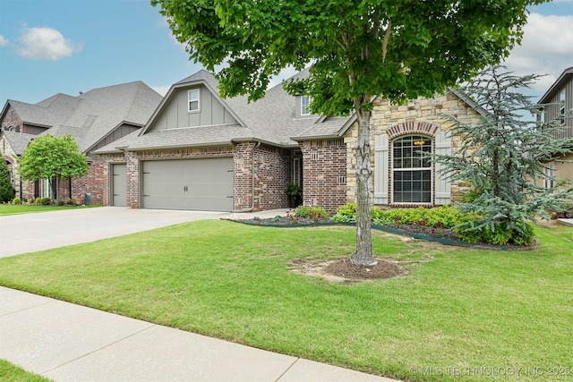 4733 S 167th E Pl, Tulsa, OK 74134 - view of front of home with a front lawn, a shingled roof, brick siding, and driveway