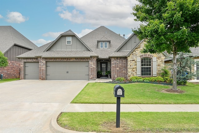 4733 S 167th E Pl, Tulsa, OK 74134 - view of front facade with board and batten siding, a front yard, a garage, driveway, and roof with shingles