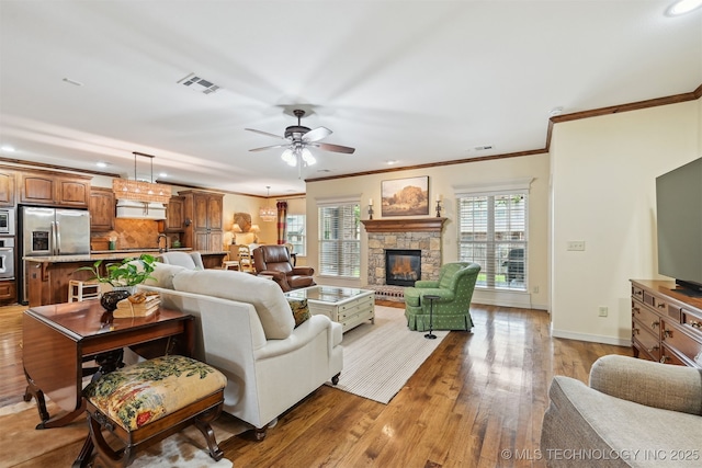 4733 S 167th E Pl, Tulsa, OK 74134 - living room with recessed lighting, a fireplace, crown molding, light wood-style floors, and a ceiling fan