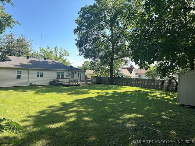 119 E Quesenbury, Sallisaw, OK 74955 - fenced backyard featuring a wooden deck and an outdoor structure