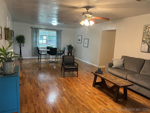 119 E Quesenbury, Sallisaw, OK 74955 - living room featuring a ceiling fan and wood-type flooring