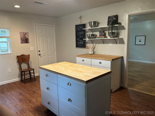119 E Quesenbury, Sallisaw, OK 74955 - kitchen featuring butcher block counters, dark wood-style floors, open shelves, recessed lighting, and a kitchen island