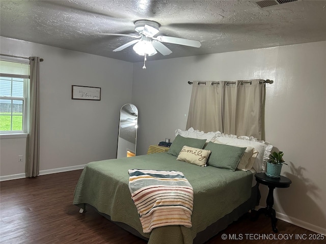 119 E Quesenbury, Sallisaw, OK 74955 - bedroom with wood finished floors, a textured ceiling, and ceiling fan