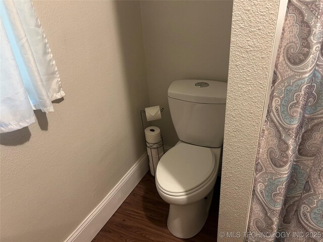 119 E Quesenbury, Sallisaw, OK 74955 - bathroom featuring toilet and wood finished floors