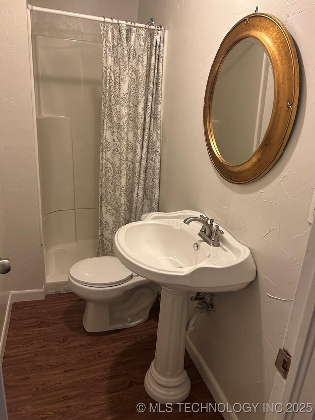 119 E Quesenbury, Sallisaw, OK 74955 - bathroom with wood finished floors and a stall shower