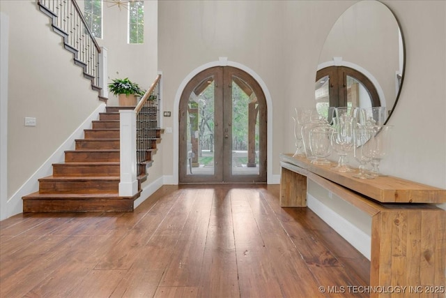20565 E Clear Brook Rd, Owasso, OK 74055 - foyer entrance featuring french doors, stairs, wood-type flooring, and a high ceiling