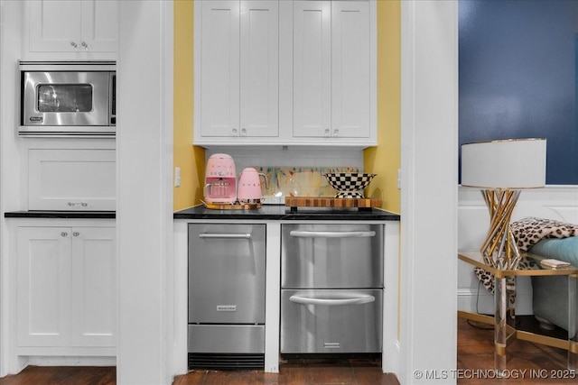 20565 E Clear Brook Rd, Owasso, OK 74055 - kitchen with stainless steel appliances, dark countertops, white cabinets, decorative backsplash, and dark wood-style flooring