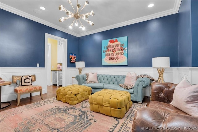 20565 E Clear Brook Rd, Owasso, OK 74055 - living room featuring a chandelier, a wainscoted wall, ornamental molding, recessed lighting, and wood finished floors