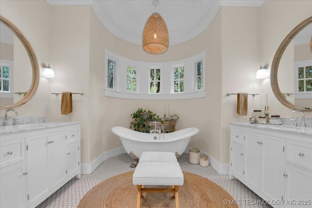 20565 E Clear Brook Rd, Owasso, OK 74055 - full bath featuring two vanities, tile patterned floors, and a freestanding tub