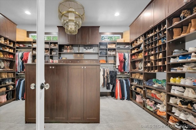20565 E Clear Brook Rd, Owasso, OK 74055 - spacious closet with light carpet and a chandelier