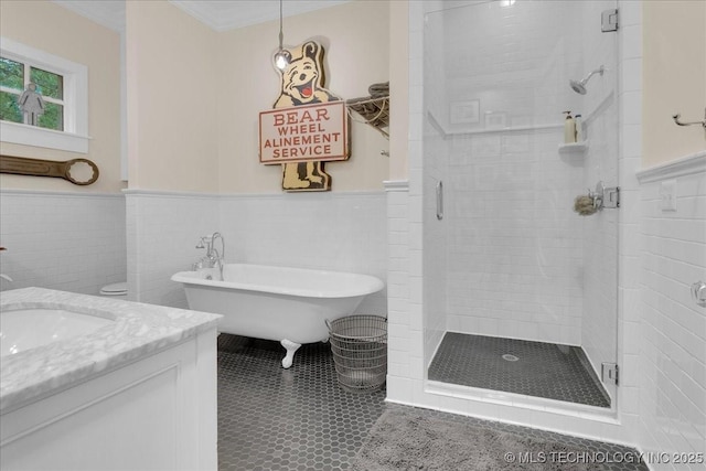 20565 E Clear Brook Rd, Owasso, OK 74055 - full bath with a wainscoted wall, a shower stall, a freestanding bath, vanity, and tile patterned floors