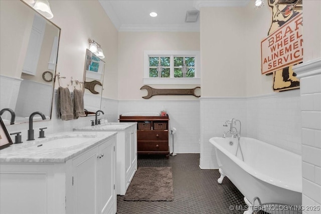 20565 E Clear Brook Rd, Owasso, OK 74055 - bathroom with tile patterned flooring, double vanity, a soaking tub, crown molding, and wainscoting