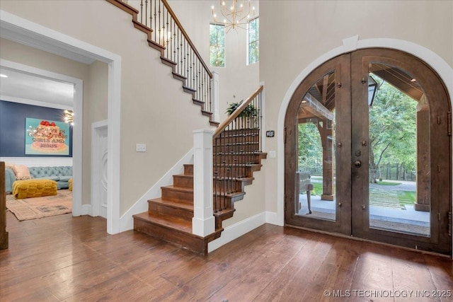 20565 E Clear Brook Rd, Owasso, OK 74055 - entrance foyer featuring french doors, wood-type flooring, stairs, and arched walkways