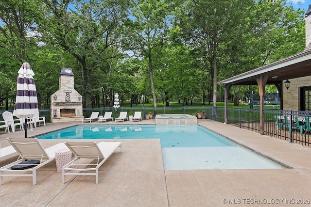 20565 E Clear Brook Rd, Owasso, OK 74055 - view of swimming pool with an outdoor stone fireplace, a patio area, a pool with connected hot tub, and view of wooded area