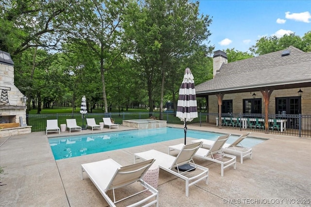 20565 E Clear Brook Rd, Owasso, OK 74055 - view of swimming pool with an outdoor stone fireplace, a patio area, and a pool with connected hot tub