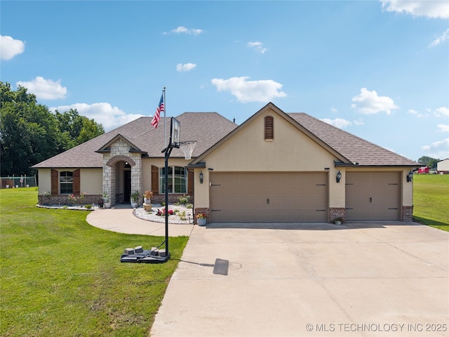 14400 E Willow Way, Claremore, OK 74019 - french provincial home featuring brick siding, a garage, a front yard, concrete driveway, and roof with shingles