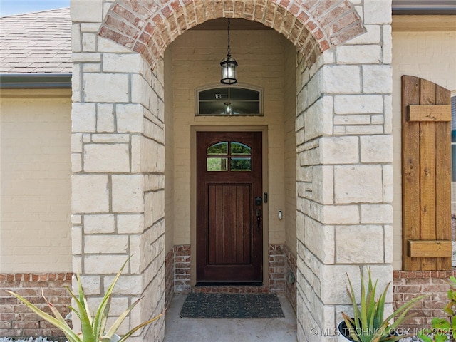 14400 E Willow Way, Claremore, OK 74019 - property entrance with stone siding, roof with shingles, and brick siding
