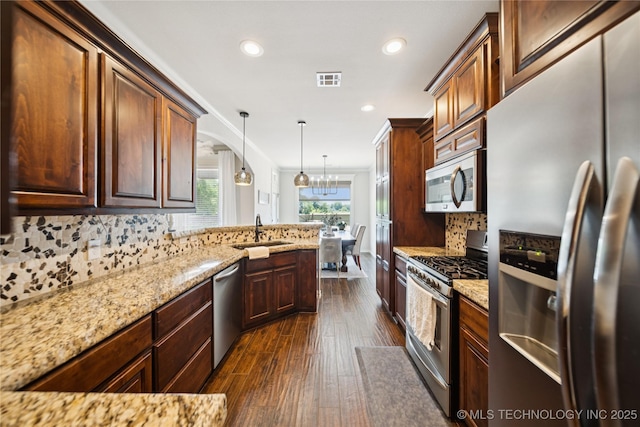 14400 E Willow Way, Claremore, OK 74019 - kitchen featuring stainless steel appliances, dark wood-style flooring, decorative backsplash, light stone counters, and recessed lighting