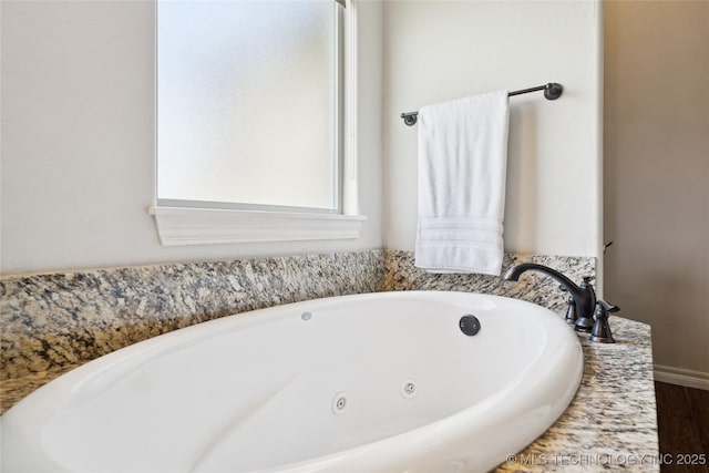 14400 E Willow Way, Claremore, OK 74019 - bathroom with a jetted tub and wood finished floors