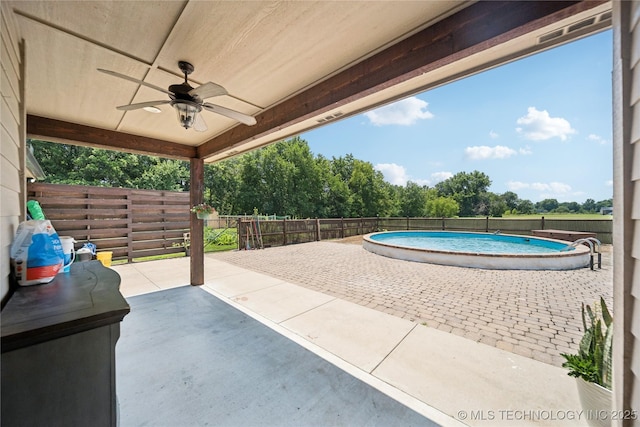 14400 E Willow Way, Claremore, OK 74019 - fenced backyard with a ceiling fan, a patio area, and view of scattered trees