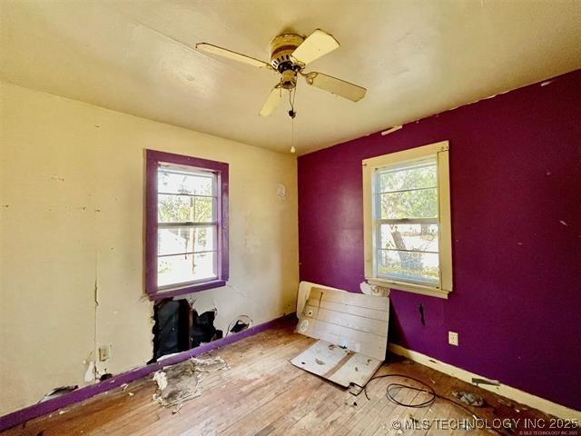 100 W Walnut Ave, Coalgate, OK 74538 - spare room with healthy amount of natural light, ceiling fan, and wood finished floors
