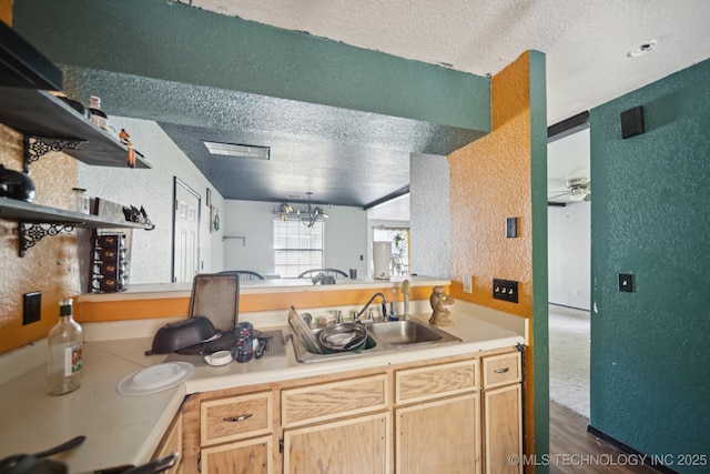 909 N Ross St, Sapulpa, OK 74066 - kitchen featuring a textured ceiling, a textured wall, a ceiling fan, light countertops, and dark wood finished floors
