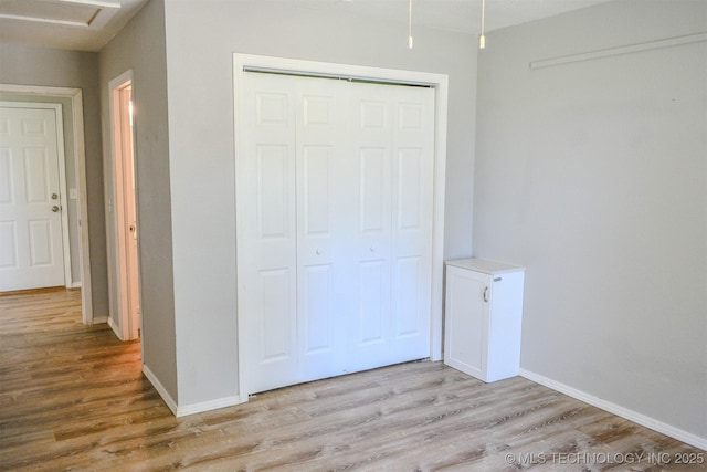3180 E 2090th Rd, Hugo, OK 74743 - unfurnished bedroom featuring wood finished floors and a closet