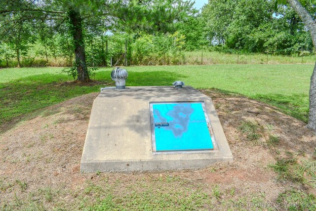 3180 E 2090th Rd, Hugo, OK 74743 - entry to storm shelter featuring a lawn and view of scattered trees