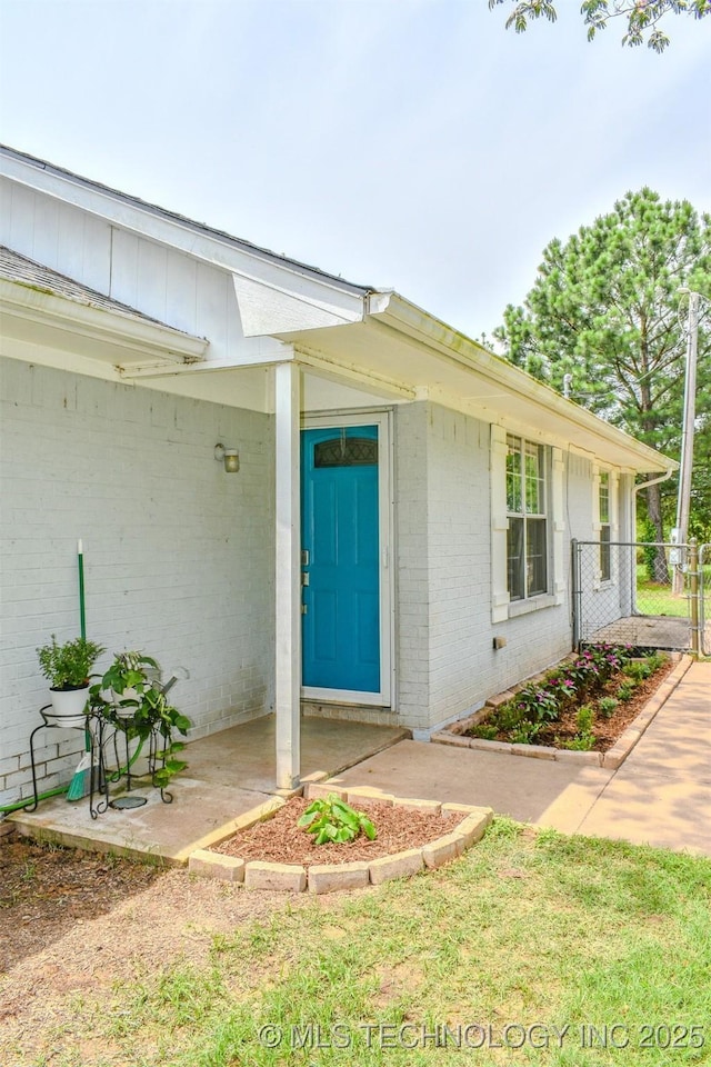 3180 E 2090th Rd, Hugo, OK 74743 - property entrance with brick siding and a gate