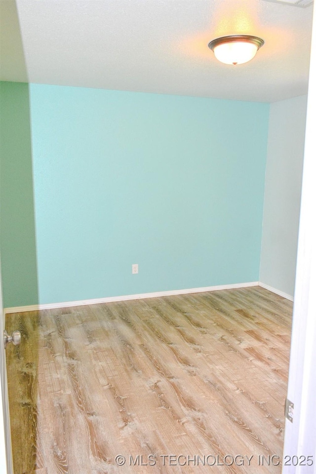 3180 E 2090th Rd, Hugo, OK 74743 - spare room featuring wood finished floors and baseboards