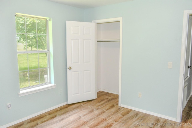 3180 E 2090th Rd, Hugo, OK 74743 - unfurnished bedroom featuring wood finished floors and a closet