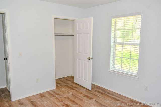 3180 E 2090th Rd, Hugo, OK 74743 - unfurnished bedroom featuring wood finished floors and a closet