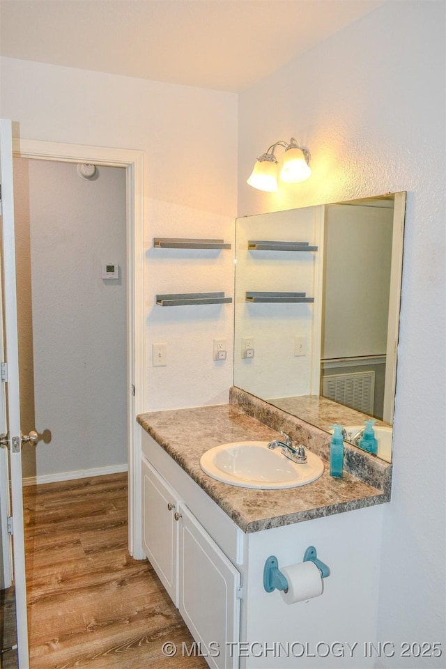 3180 E 2090th Rd, Hugo, OK 74743 - bathroom featuring vanity and wood finished floors