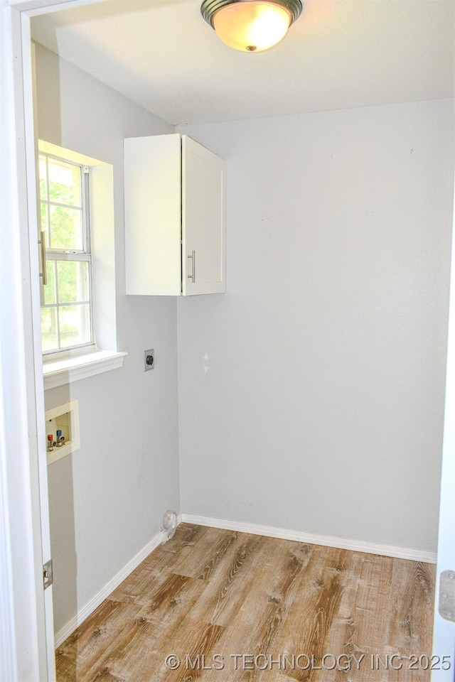 3180 E 2090th Rd, Hugo, OK 74743 - laundry room with washer hookup, cabinet space, light wood finished floors, and hookup for an electric dryer