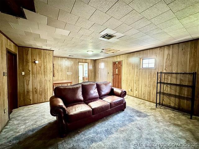 1305 7th Ave NW, Ardmore, OK 73401 - carpeted living area with wooden walls
