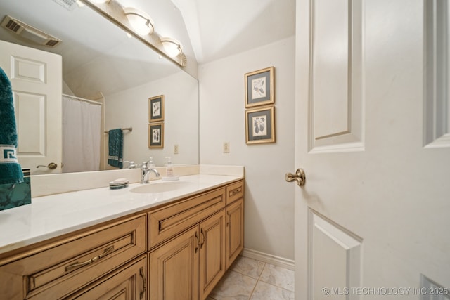 7721 E 101st Pl, Tulsa, OK 74133 - bathroom with vaulted ceiling, vanity, and marble finish floors