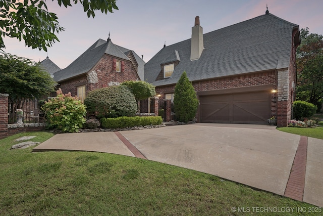 7721 E 101st Pl, Tulsa, OK 74133 - view of front facade featuring brick siding, driveway, and a yard