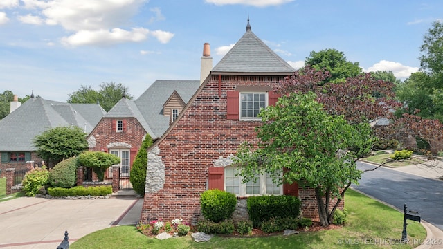 7721 E 101st Pl, Tulsa, OK 74133 - view of front facade featuring brick siding and a chimney