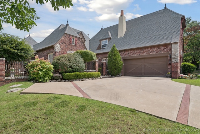 7721 E 101st Pl, Tulsa, OK 74133 - view of front facade featuring brick siding, concrete driveway, a front yard, a chimney, and roof with shingles