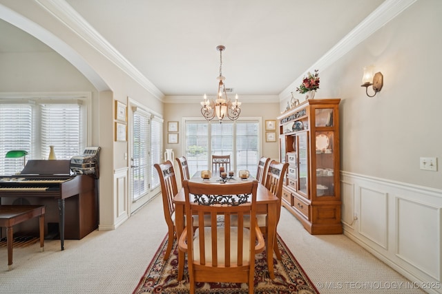 7721 E 101st Pl, Tulsa, OK 74133 - dining area featuring a chandelier, healthy amount of natural light, light colored carpet, arched walkways, and ornamental molding