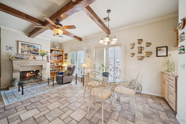 7721 E 101st Pl, Tulsa, OK 74133 - dining area with stone tile flooring, a ceiling fan, a fireplace, beamed ceiling, and ornamental molding