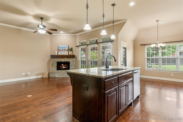 425 W 128th St S, Jenks, OK 74037 - kitchen with a fireplace, stainless steel dishwasher, a ceiling fan, a chandelier, and dark brown cabinetry