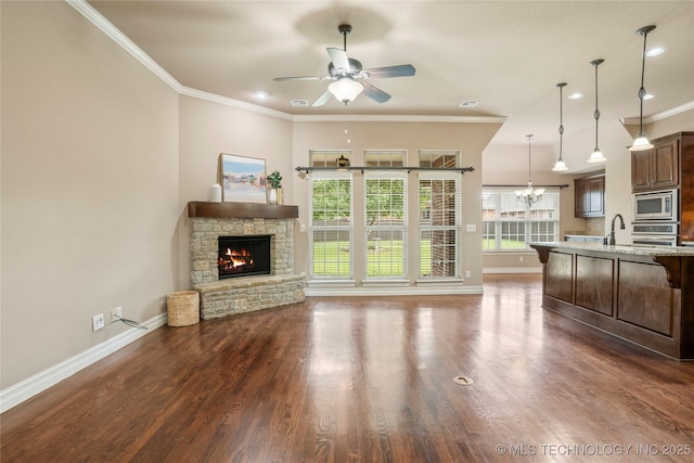 425 W 128th St S, Jenks, OK 74037 - unfurnished living room with a fireplace, ceiling fan, crown molding, dark wood finished floors, and a chandelier