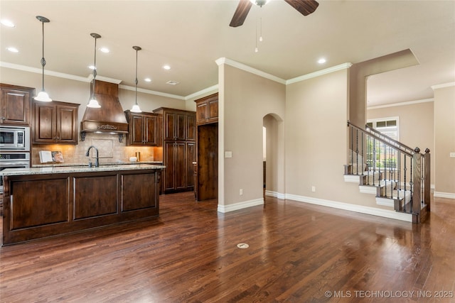 425 W 128th St S, Jenks, OK 74037 - kitchen with custom exhaust hood, stainless steel microwave, a ceiling fan, tasteful backsplash, and recessed lighting