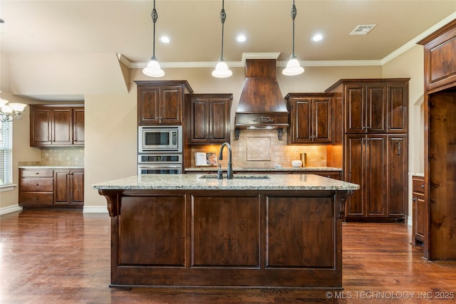 425 W 128th St S, Jenks, OK 74037 - kitchen featuring appliances with stainless steel finishes, premium range hood, light stone counters, dark wood finished floors, and crown molding