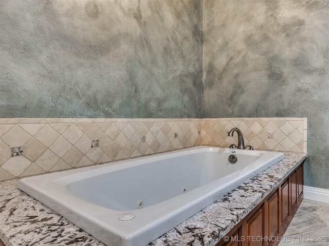 109 E Bk 800th Rd, Stigler, OK 74462 - bathroom featuring baseboards and a jetted tub
