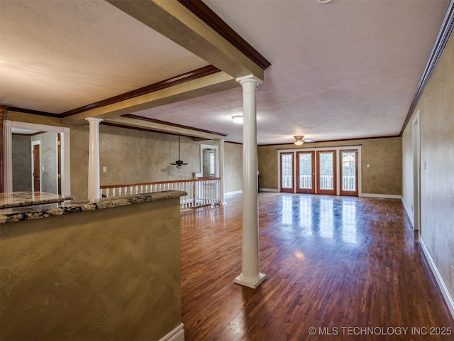 109 E Bk 800th Rd, Stigler, OK 74462 - unfurnished living room with wood finished floors, crown molding, decorative columns, a textured ceiling, and beam ceiling