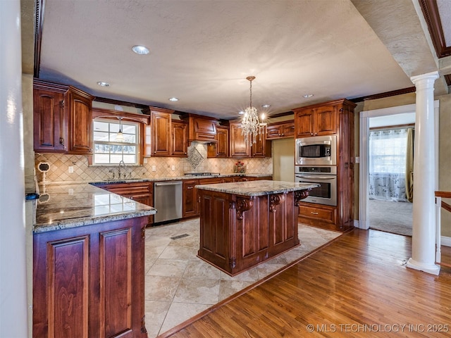 109 E Bk 800th Rd, Stigler, OK 74462 - kitchen with appliances with stainless steel finishes, plenty of natural light, backsplash, ornate columns, and crown molding